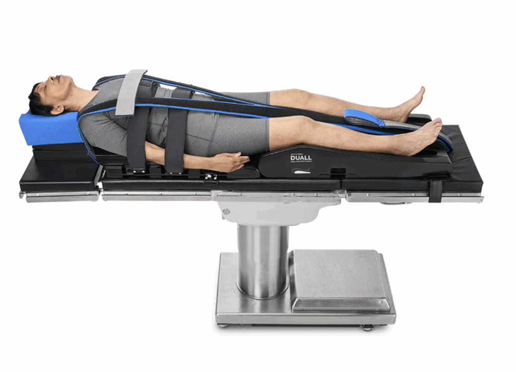 Patient's legs secured with straps on a medical examination table.
