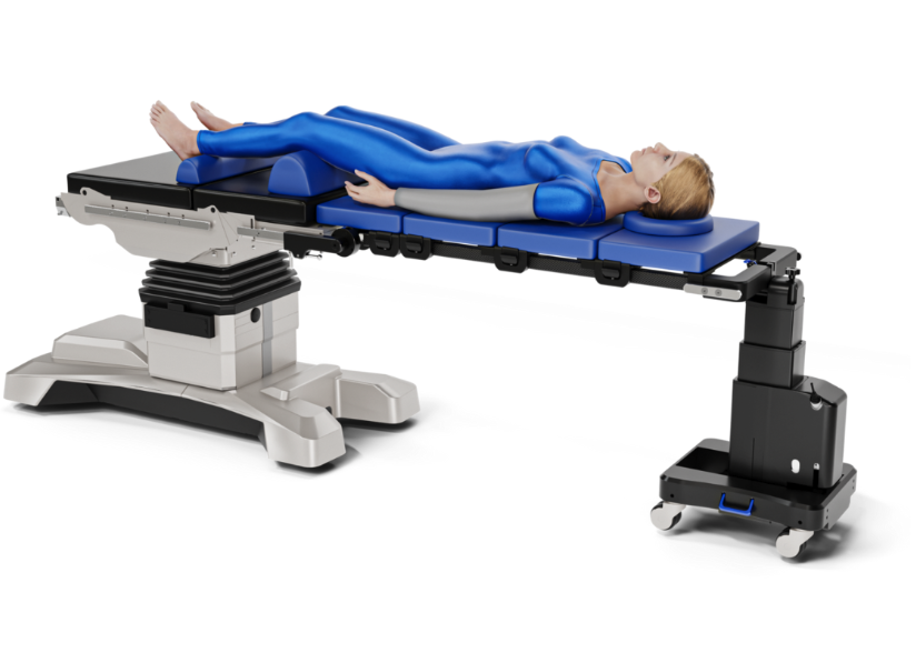Patient lying on a medical imaging table wearing a blue gown.