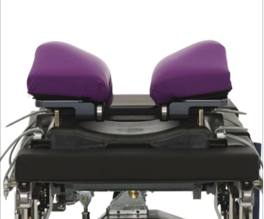 A purple cushioned wheelchair seat with adjustable side supports.