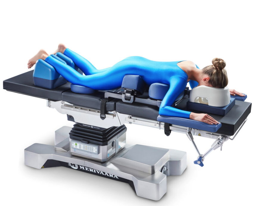Woman in blue bodysuit lying on a modern medical or therapy table.