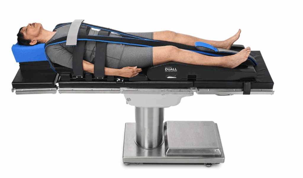 Patient positioned on a surgical table with arm secured for a medical procedure.