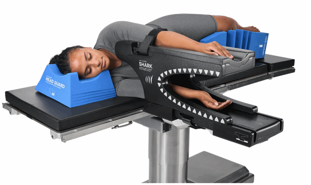 Patient positioned for spinal surgery using specialized operating table.