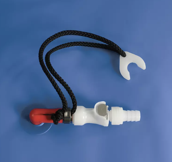 Small plastic valve with a black cord on a blue background.