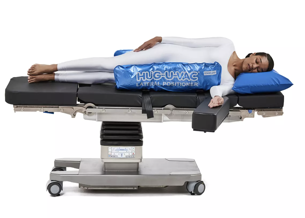 Patient lying on a medical imaging table with a blue cooling pad.