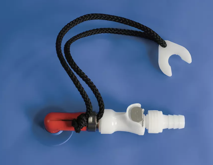 A white plastic valve with attached black cords and a red lever on a blue background.