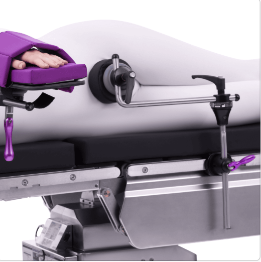 Close-up of a hospital stretcher with purple straps and a gray mattress.