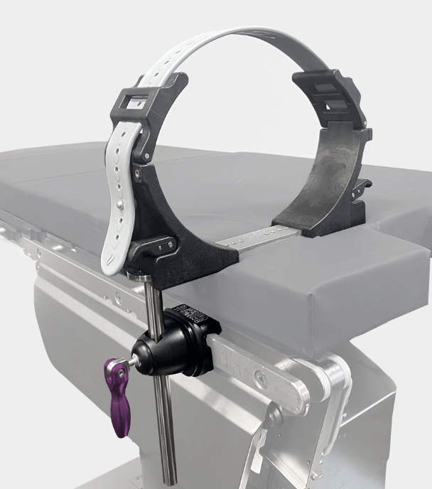 Metal wrist restraint attached to a medical or examination table.