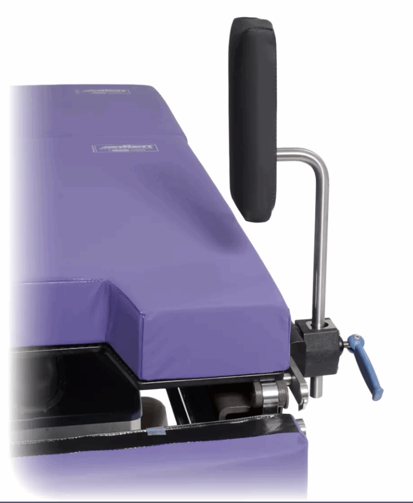 Close-up of a purple industrial machine part with a black handle and metal components.