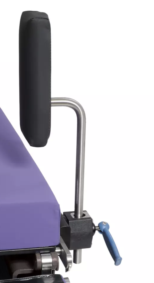 Close-up of a wheelchair's armrest and purple seat.