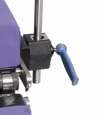 Close-up of a metal machine part with a blue lever handle.