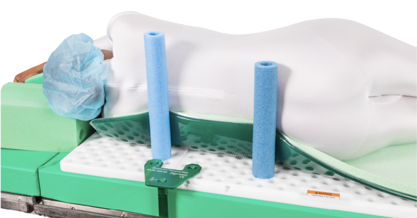 Two blue foam pool noodles standing upright on a white surface with a green base.