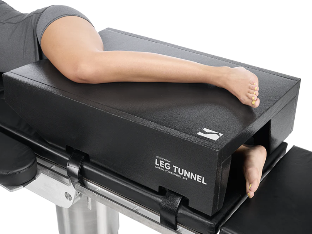 Person's arm resting on a leg tunnel pad during exercise.