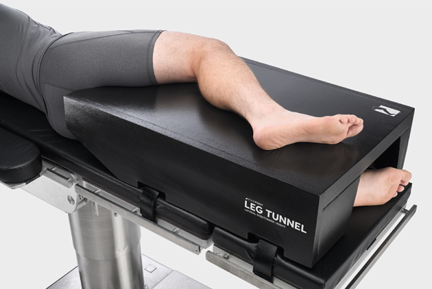 A leg resting on a black medical device labeled 'LEG TUNNEL'.
