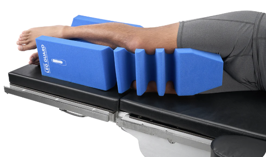 A blue armrest support on a medical examination table.