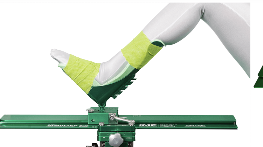 A prosthetic leg with a lime green support brace on a medical testing device.