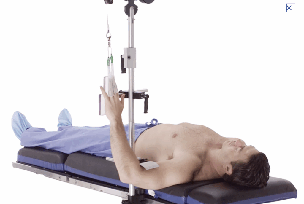 Patient lying on hospital bed receiving IV treatment.