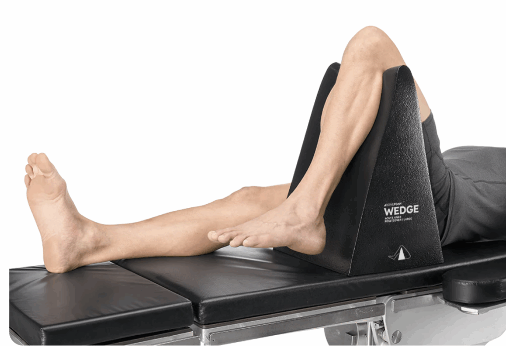 Person exercising leg muscles using a resistance device on a bench.