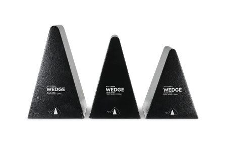 Three black triangular guitar wedges of different sizes.