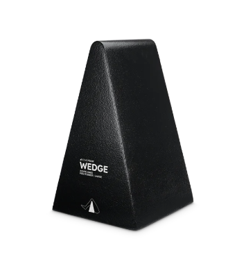 Black wedge-shaped metronome with a smooth surface.