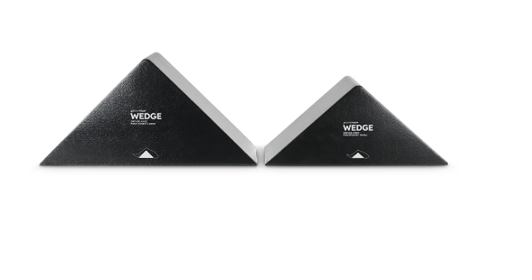 Two black wedge-shaped cushions positioned side by side on a white background.