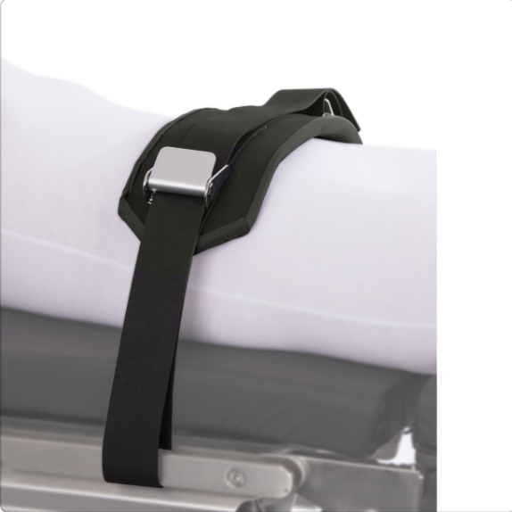 Black strap securing a mattress or cushion on a metal frame.