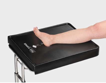 Person's foot on a medical foot examination device.