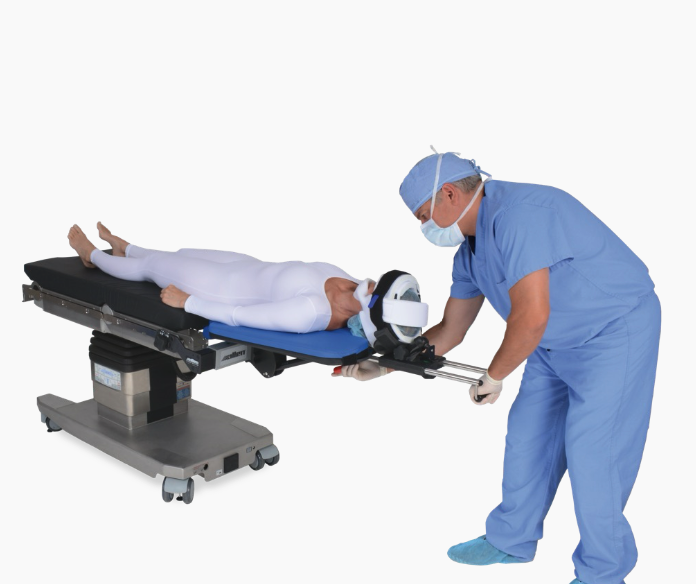 Medical professional adjusting patient on MRI scanner table.