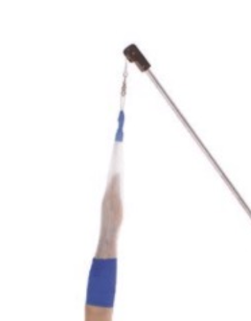 A hand holding a blue and white toothbrush with toothpaste on it.