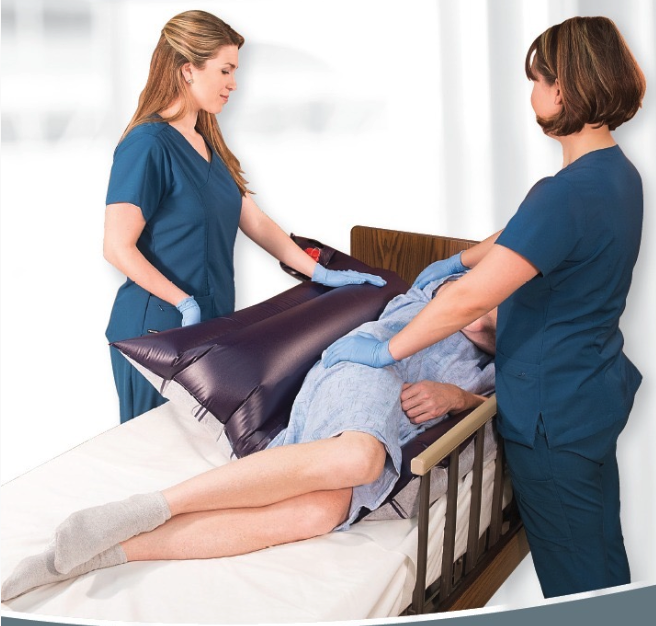 Two healthcare workers assist a patient with a mobility aid in a care setting.